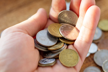 Hand holding full of coins palm payment donation concept economy finance