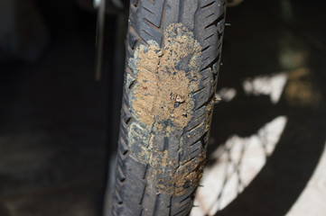 details of dirty motorcycle tire with horse stool (manure) on tire wheel