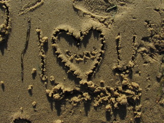 A heart drawing on sand