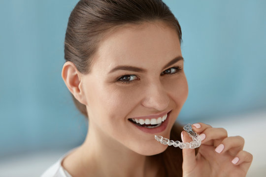 Dental Care. Smiling Woman Using Removable Clear Teeth Braces