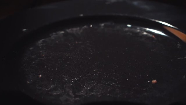 Close-up of chef cook taking a cutlet from the black pan for cooking hamburgers. Stock footage. Chef making hamburger patty in kitchen with ground beef