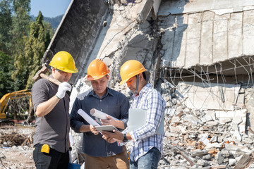 Demolition control supervisor and contractor discussing on demolish building.