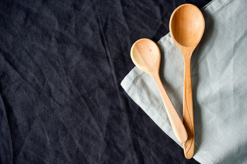 Background - wooden spoons on the tablecloth. Copy space, top view.