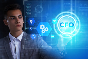 The concept of business, technology, the Internet and the network. A young entrepreneur working on a virtual screen of the future and sees the inscription: CFO