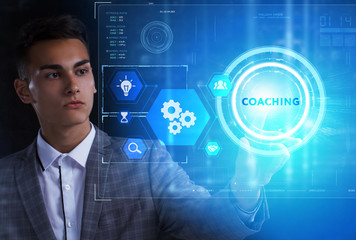 The concept of business, technology, the Internet and the network. A young entrepreneur working on a virtual screen of the future and sees the inscription: Coaching