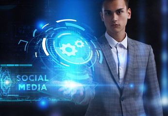 The concept of business, technology, the Internet and the network. A young entrepreneur working on a virtual screen of the future and sees the inscription: Social media
