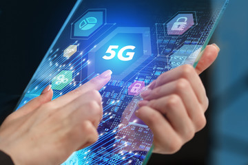 The concept of business, technology, the Internet and the network. A young entrepreneur working on a virtual screen of the future and sees the inscription: 5G