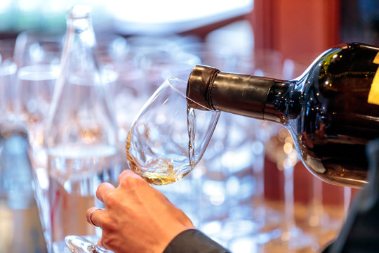 serving a glass of white wine