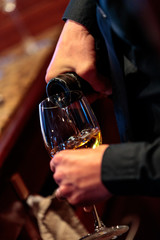 serving a glass of white wine