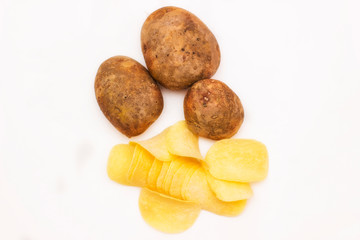 Potato chips with fresh potatoes on a white background