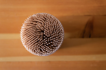The box of toothpicks top view with the wooden table background - Image