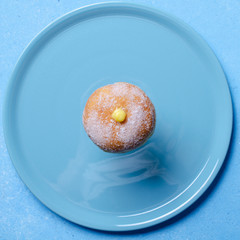 Doughnuts with creamy  filling. Copy space. Blue backgroung