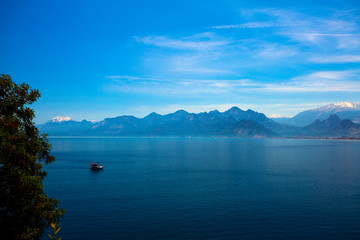 Beautiful landscape of mountains and ship in the Mediterranean sea in Turkey, Antalya.