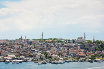 Eminönü skyline in Istanbul, view of architecture and ships on a golden horn and mosque Suleymaniye