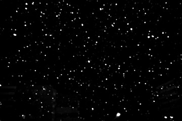 Naklejka na ściany i meble falling snow on a black background, snowfall at night, white chaotic spots on a black background