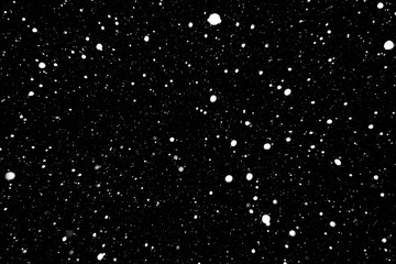 falling snow on a black background, snowfall at night, white chaotic spots on a black background