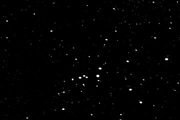falling snow on a black background, snowfall at night, white chaotic spots on a black background