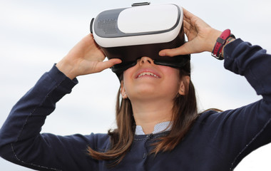 Caucasian little girl with virtual reality headset during a simu
