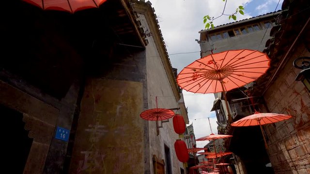 Red umbrellas covering narrow streets on Fenghuang ancient town, Hunan province, China