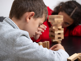 Obraz premium Portrait of boy and girl playing boardgames