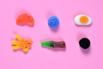 top view of jelly candies collection on pink background