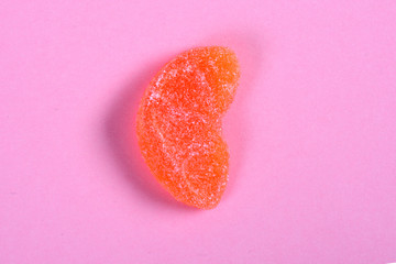 orange fruit jelly candy on pink background