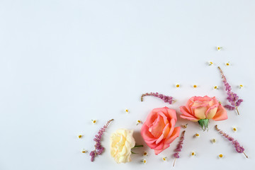 Feminine frame background made of various flowers with a lot of copy space for text. Close up, top view, flat lay.