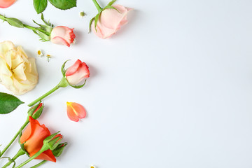 Feminine frame background made of various flowers with a lot of copy space for text. Close up, top view, flat lay.