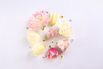 Feminine frame background made of various flowers with a lot of copy space for text. Close up, top view, flat lay.