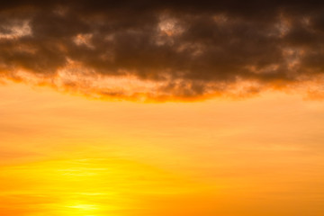 Golden cloudy sky with dark texture cloud backgroun in twilight 