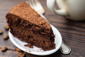 A slice of chocolate cake and a cup of coffee