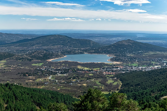 Views from the mountains to the Navacerrada reservoir and the town of Becerril de la Sierra, in a magnificent landscape from above. Photography made in Madrid. Spain.