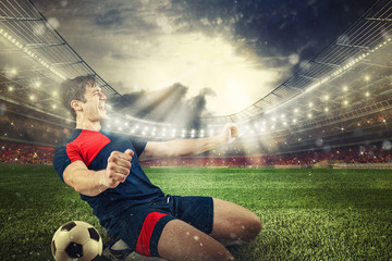 Soccer striker rejoices for the victory at the stadium