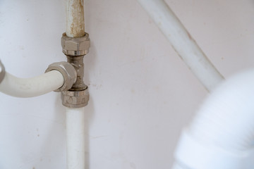 Old connection fitting tee on plastic pipes