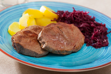 Veal steak with potato and sauerkraut