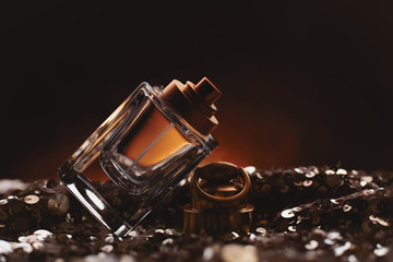 female bottle of perfume on dark background