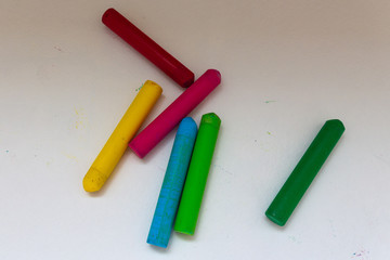 Yellow, brown, green, blue and pink crayons