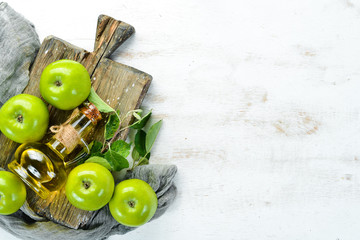 Apples and apple vinegar on the old background. Fruits. Top view. Free space for text.