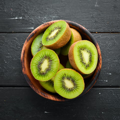 Fresh Kiwi on a black background. Top view. Free space for your text.