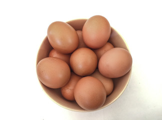 Eggs: brown eggs in separate cups on a white background in close-up shot from top to bottom Thailand
