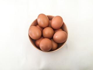 Eggs: brown eggs in separate cups on a white background in close-up shot from top to bottom Thailand