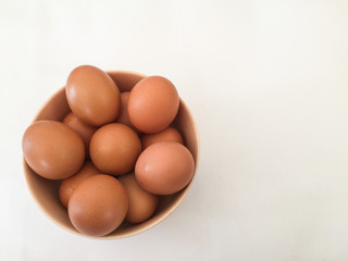 Eggs: brown eggs in separate cups on a white background in close-up shot from top to bottom Thailand