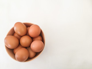 Eggs: brown eggs in separate cups on a white background in close-up shot from top to bottom Thailand
