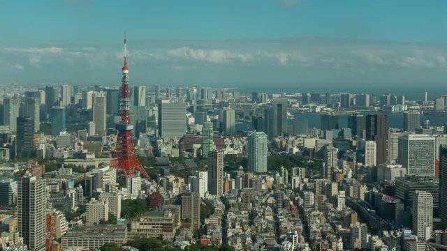 4K, zoom out planning shot ,Time lapse view of Tokyo Tower with blue sky and cloud, cityscape view landmark of Japan, cityscape, landscape and travel concept