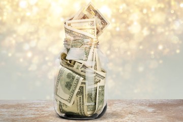 Glass jar for money  on background