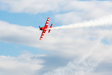 Light engine airplane with a trace of white smoke