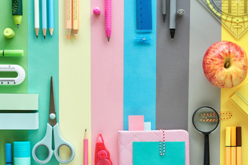 Stationary items on pastel color paper background, back to school flat lay concept