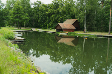 the calm bay creates nice shadows in the water by nature and by the boat house