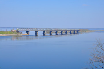 Fototapeta premium wide river Dnieper. Across the river concrete bridge