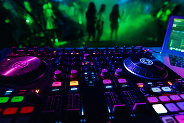 professional DJ mixer controller for mixing music in a nightclub
